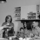 A happy family enjoys a meal together at home. Perfect for celebrating togetherness.
