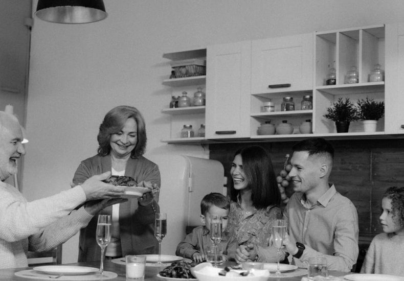 A happy family enjoys a meal together at home. Perfect for celebrating togetherness.